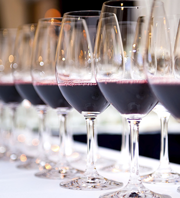 Glasses of red wine in a row on a table